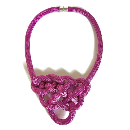 Model shows how the Alter Ego Designs Brave necklace fastens easily with a strong magnetic clasp