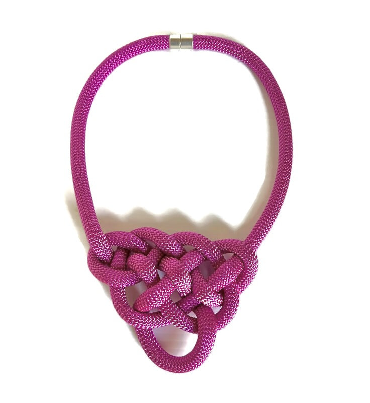 Model shows how the Alter Ego Designs Brave necklace fastens easily with a strong magnetic clasp